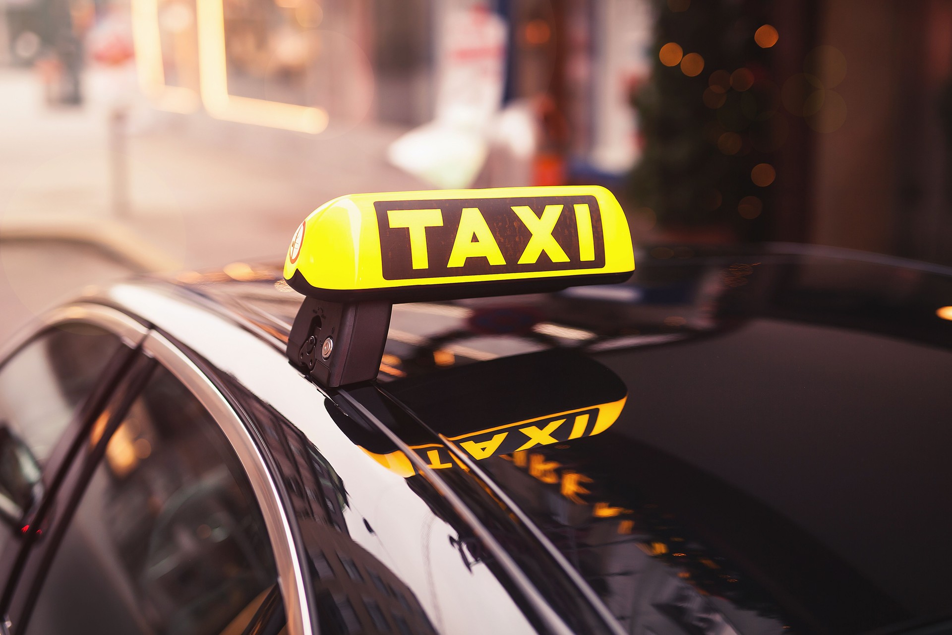 yellow taxi car roof sign at night. taxi car on the street at night